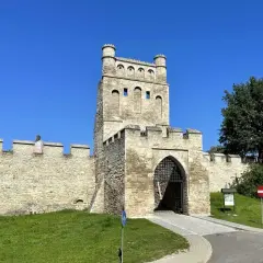 Kamienna brama z wieżą, przypominająca polskie Carcassonne, strzeże wejścia do zabytkowego miasta.