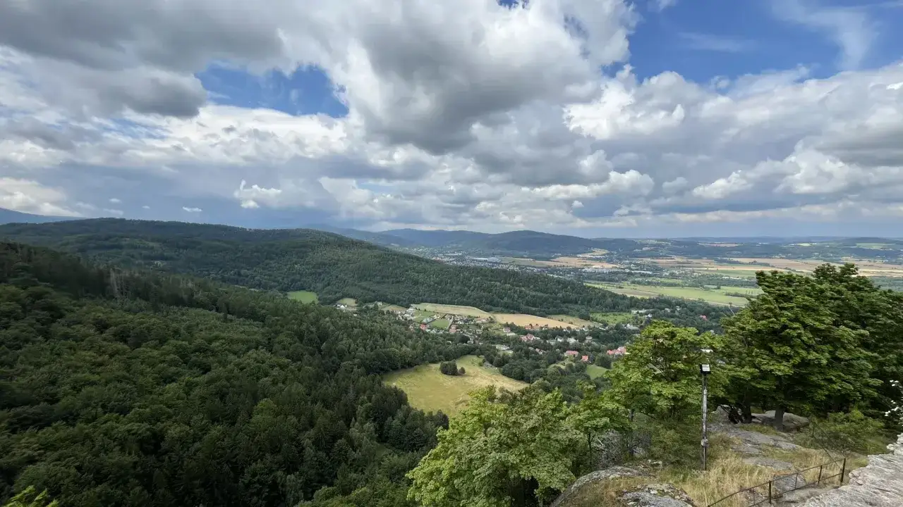 Widok na góry i dolinę z miasteczkiem, idealne miejsce na odkrywanie atrakcji Karkonoszy.